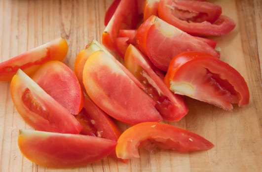 Sliced ​​tomato paste on a wooden cutting board.