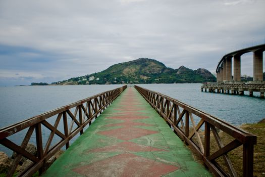 guidelines of a pier  leading to a hill