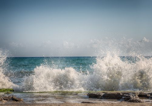 HDR water splashing in sea water on background of blue sky