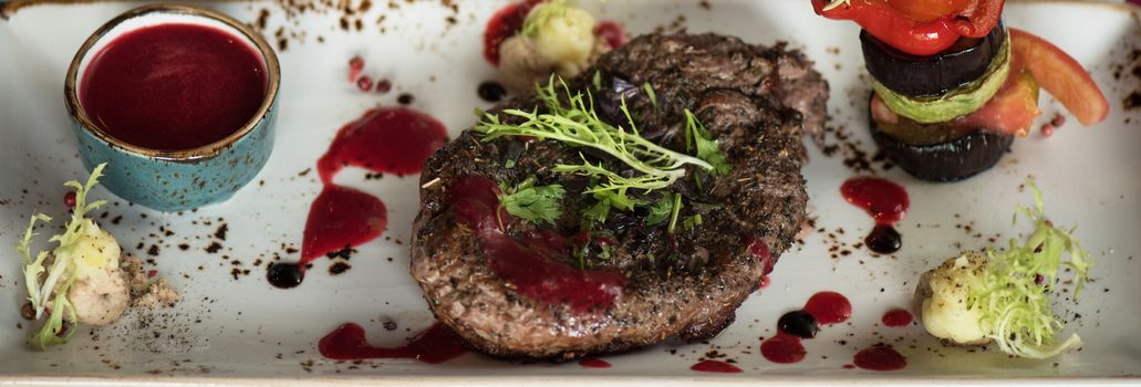 grilled beef steak with herbs vegetables and sauce