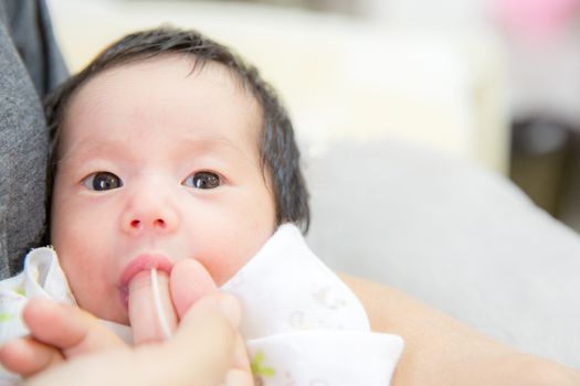 newborn baby Finger Feeding breast milk using tube
