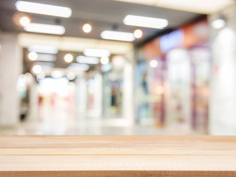 Wooden board empty table in front of blurred background. Perspective light wood over blur in shopping mall - can be used for display or montage your products. Mock up for display of product.