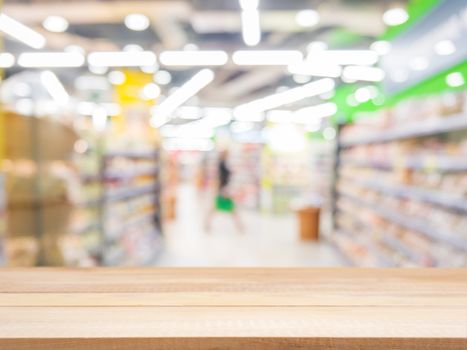 Wooden board empty table in front of blurred background. Perspective light wood over blur in supermarket - can be used for display or montage your products. Mock up for display of product.