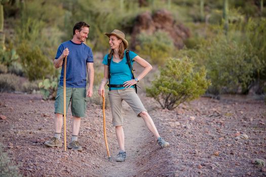 Fun couple hiking nature trail in the American Southwest