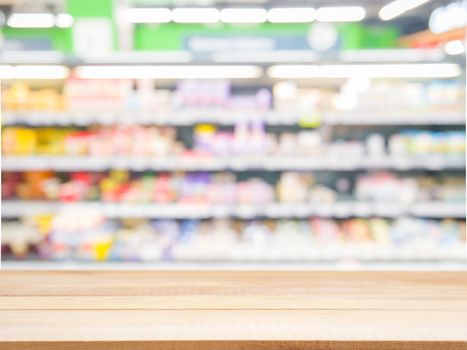 Wooden board empty table in front of blurred background. Perspective light wood over blur in supermarket - can be used for display or montage your products. Mock up for display of product.