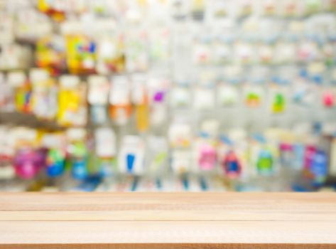 Wooden board empty table in front of blurred background. Perspective light wood over blur in kids toys store - can be used for display or montage your products. Mock up for display of product.