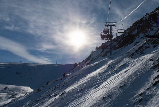 Skiing and snowboarding on the snowy slopes of prepared ski resort in Andorra