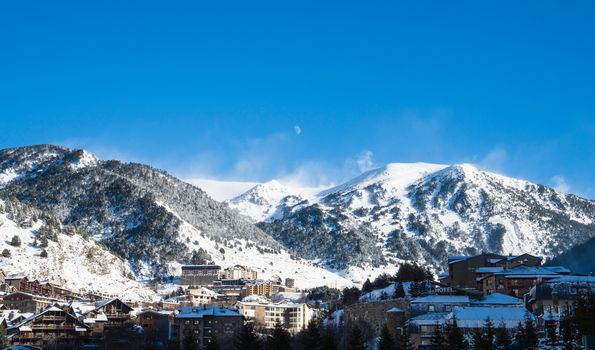 Skiing and snowboarding on the snowy slopes of prepared ski resort in Andorra