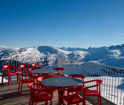 Skiing and snowboarding on the snowy slopes of prepared ski resort in Andorra