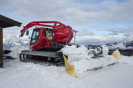 Red snowcat dub snow on the slopes of the Alps