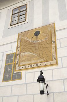 sundial on the white wall of the house a cloudy day did not show time