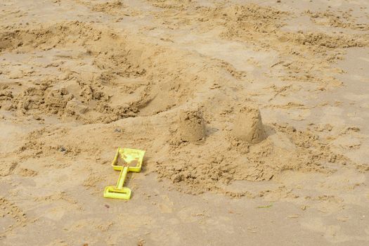 Kids spade by broken down sandcastle