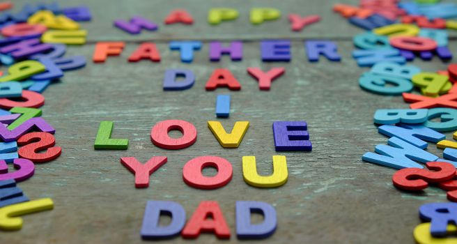 I love you dad message for father, group of colourful letters to happy father day, wooden alphabet wood background