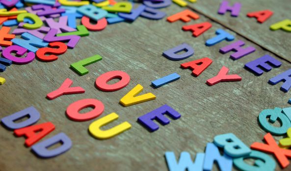 I love you dad message for father, group of colourful letters to happy father day, wooden alphabet wood background