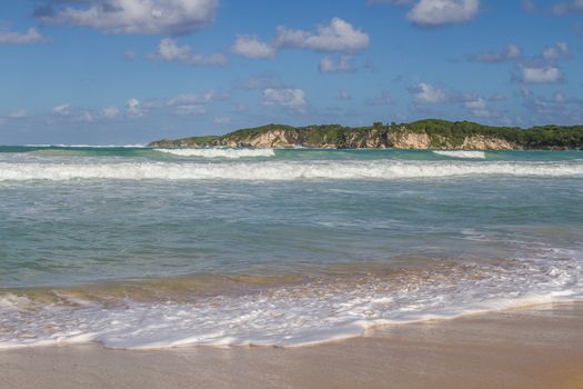 the coast with sandy beaches washed by the wave