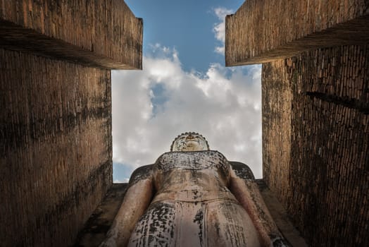 Giant statue of Buddha in the Mahathat temple of Sukhothai