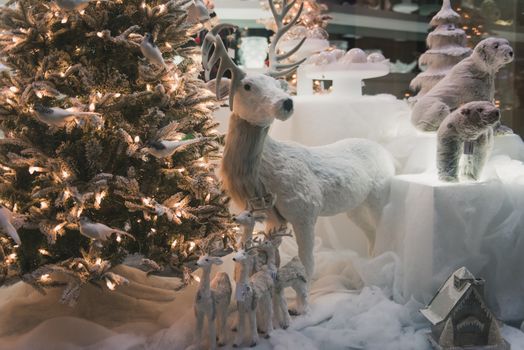 Christmas decoration with tree and snow in a window shop