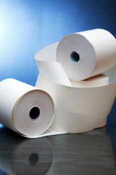 White paper rolls with reflection on dark background