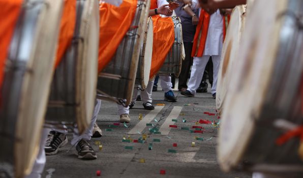 Traditional percussion instruments caled Dhol been played uring a Ganesh festival procession in India.