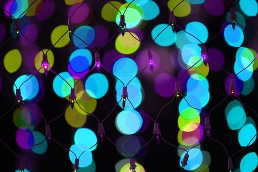 A wire mesh of colorful decoration light on the backdrop of other colorful lights