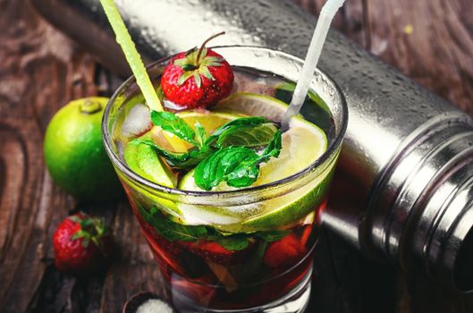 Popular alcoholic cocktail with lime,mint and strawberries