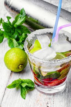 Popular alcoholic cocktail with lime,mint and strawberries