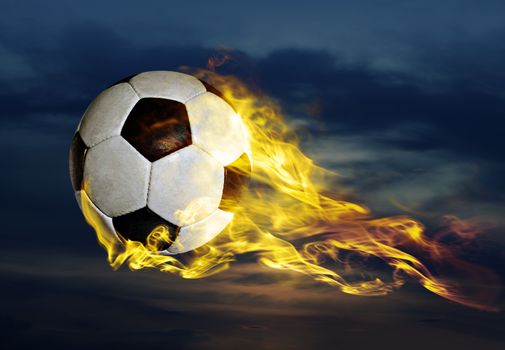 flying fiery soccer ball in sky