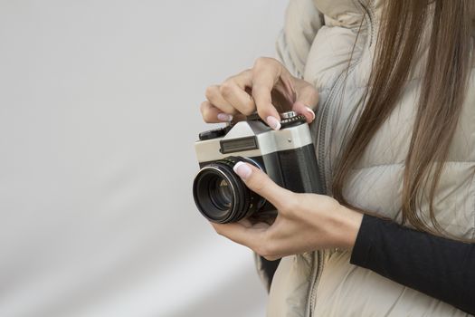 the girl in the hands of is holding the vintage camera
