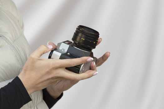 the girl in the hands of is holding the vintage camera