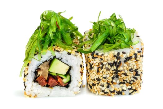 Uramaki maki sushi, two rolls isolated on white. Philadelphia cheese, eel, cucumber, dried tomatoes, avocado and sesame. Chuka seaweed on top.