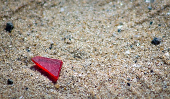 Red glass on the sand