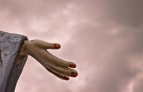 Close up of statue hand against cloudy sky