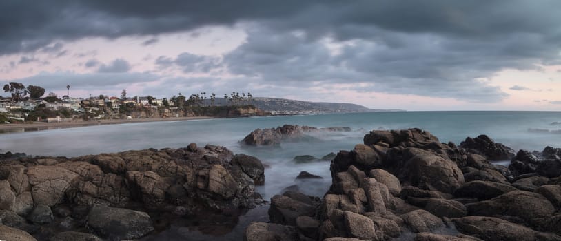 Rain clouds over Crescent Bay at sunset in the fall in Laguna Beach, California, United States