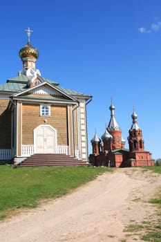 Old Russian abbey against blue sky at summer