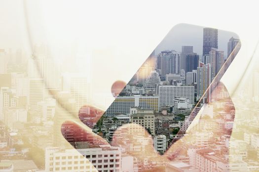Double exposure image of businessman sitting in the airplane and using smart phone with cityscape background, Business technology concept.