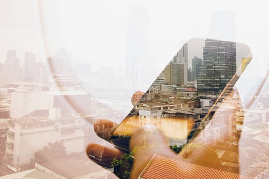 Double exposure image of businessman sitting in the airplane and using smart phone with cityscape background, Business technology concept.