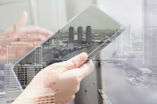 Using digital tablet double exposure and and cityscape background. Business technology concept.