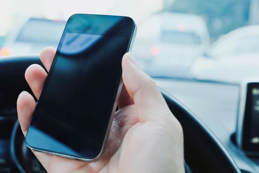Businessman Sitting in the Car and Using Smart Phone