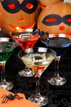 Glasses with different drinks on the table in honor of Halloween