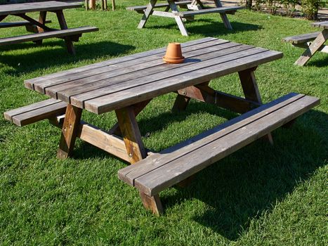 Rustic style Picnic Table made of wood in a beautiful garden