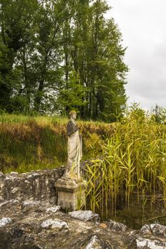 Ancient ruins and statue in the Dion Archeological Site in Greece