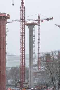 Bridge construction sites, bridge under construction seen in heavy snowfall from below.