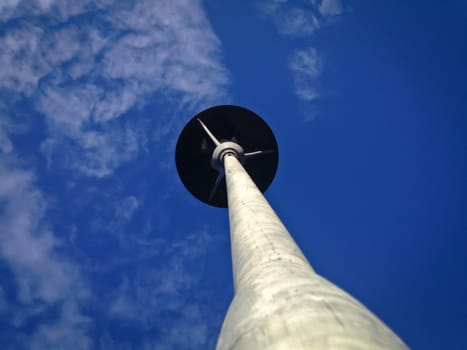 Lighting pole with blue sky and clouds