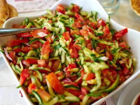 Classic famous Israeli salad made of freshly cut vegetables