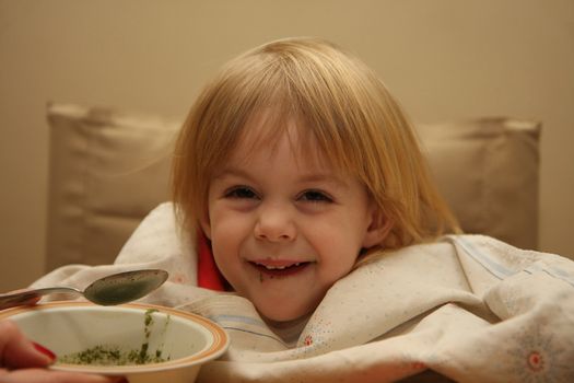 Young girl enjoys eating nettle chowder