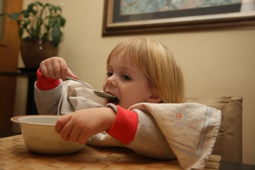 Young girl enjoys eating nettle chowder