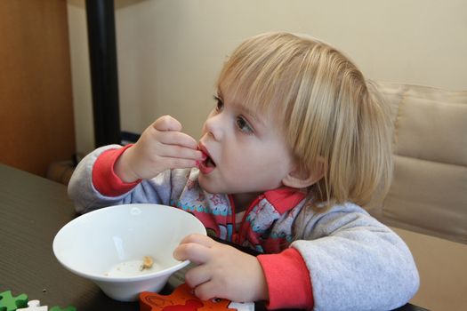 Young girl enjoys eating peanuts