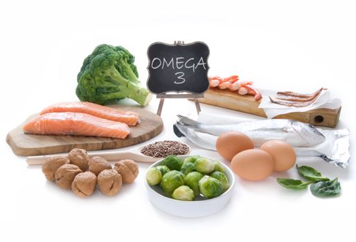 Collection of foods high in fatty acids omega 3 including seafood, vegetables and seeds over a white background