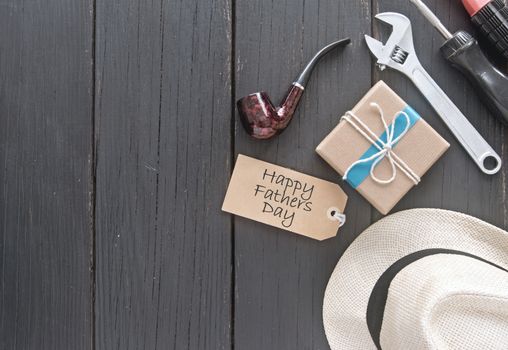 Fathers day gift box with a label, tools, hat and pipe