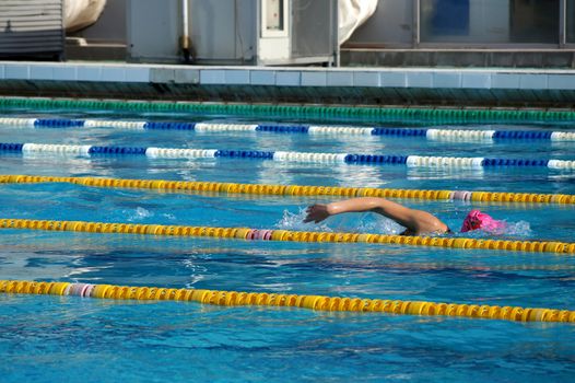 Girl swimmer in the outdoor swimming pool